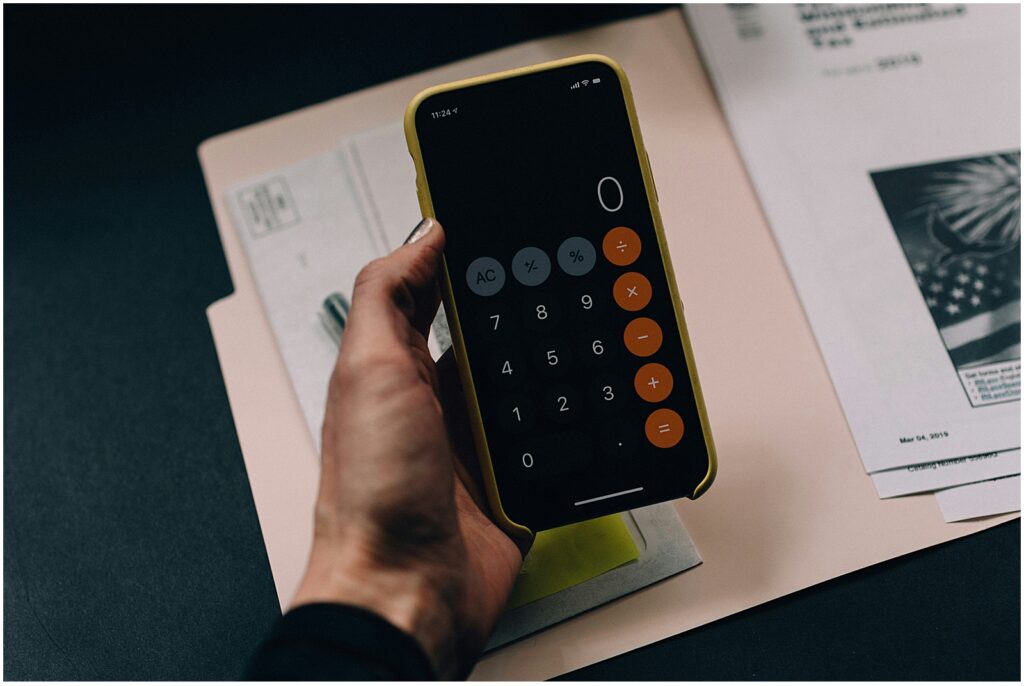 Woman holding a calculator to calculate sales tax on artwork