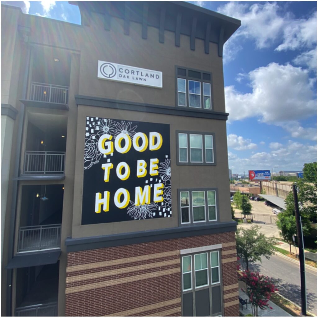 Black and yellow mural with floral designs that says Good To Be Home by Alli K Design