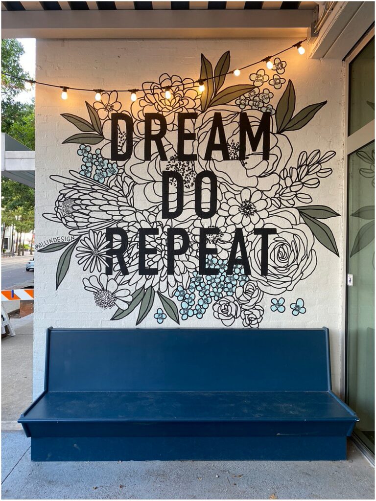 Floral mural that says Dream Do Repeat at Dream Cafe in Dallas, painted by Alli K Design