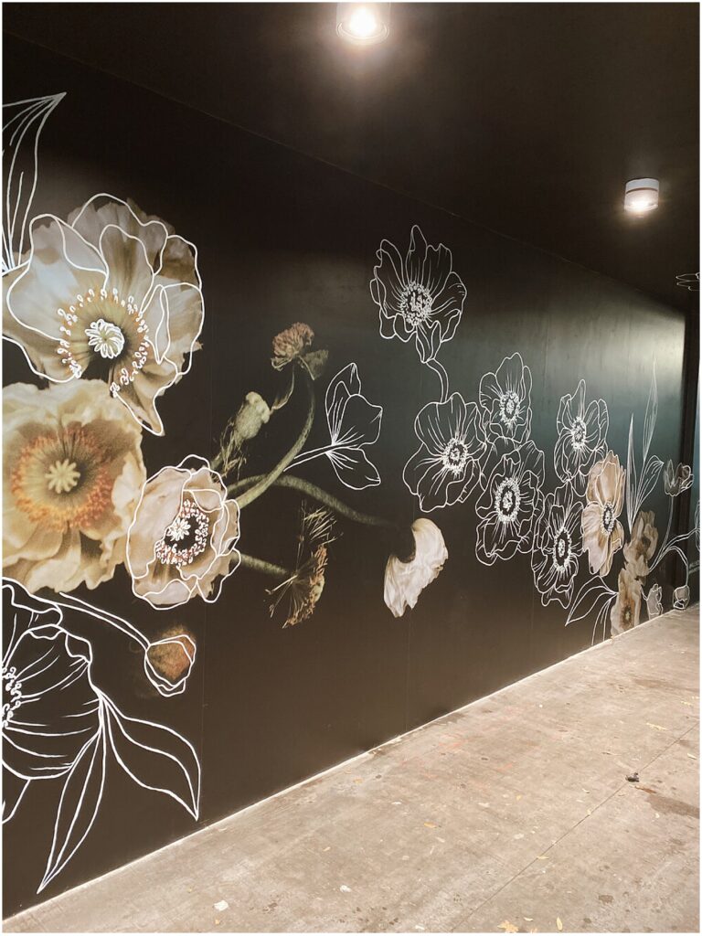 Floral mural on a black wall by Texas muralist Alli K