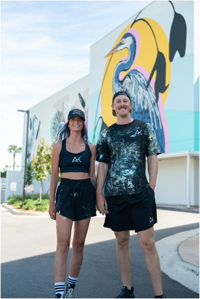 Alli and Landon Koch of Alli K Design in front of a mural they painted in Orlando, FL